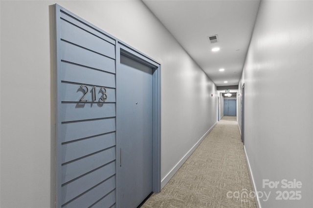 hallway featuring recessed lighting, visible vents, and baseboards