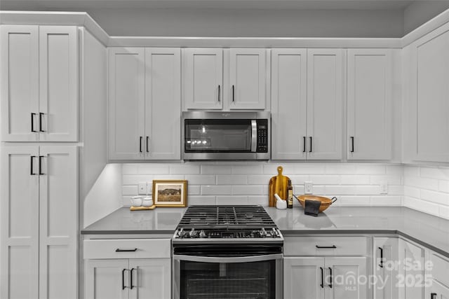 kitchen featuring white cabinetry, tasteful backsplash, and appliances with stainless steel finishes