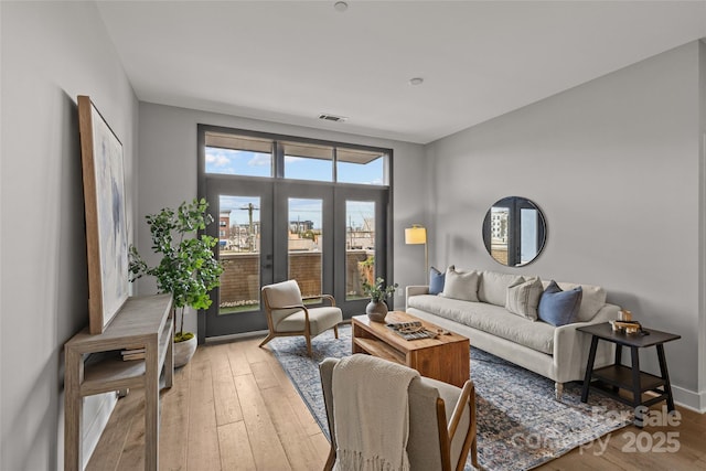 living room featuring light wood finished floors and visible vents