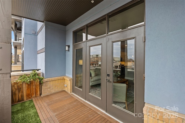 entrance to property featuring french doors and stucco siding