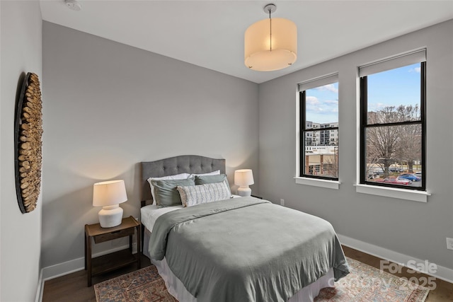 bedroom featuring baseboards and wood finished floors