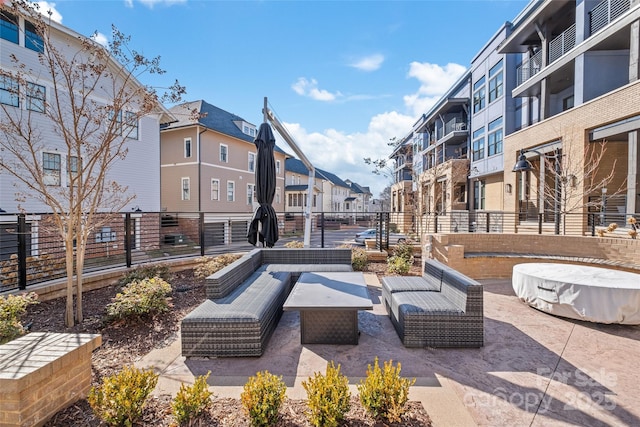 view of property's community featuring a residential view, a patio area, fence, and an outdoor hangout area