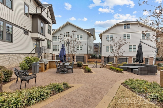 view of home's community with a patio area, outdoor lounge area, and an outdoor kitchen