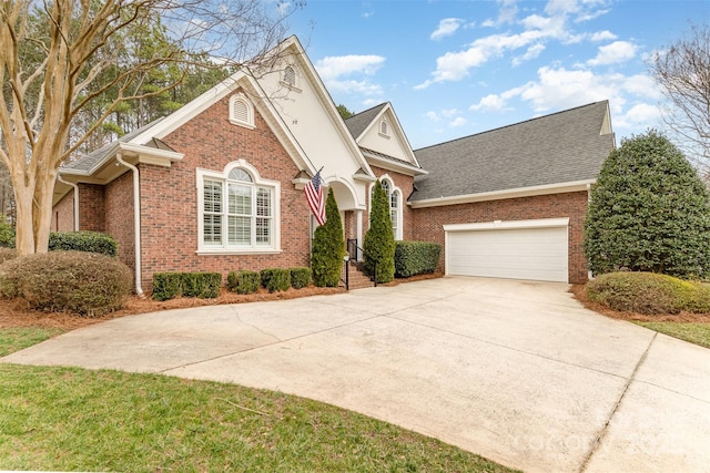 view of front of property with concrete driveway, brick siding, and an attached garage