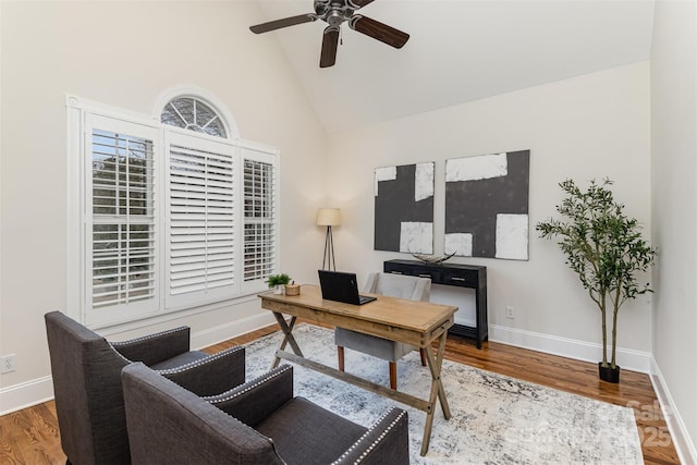 office space featuring ceiling fan, high vaulted ceiling, wood finished floors, and baseboards