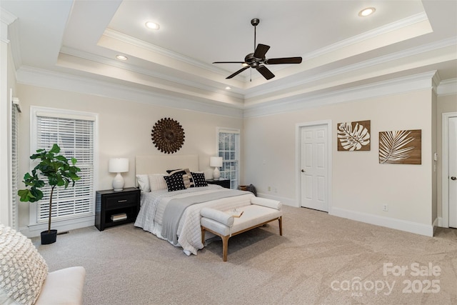 bedroom with light carpet, a tray ceiling, ornamental molding, and baseboards