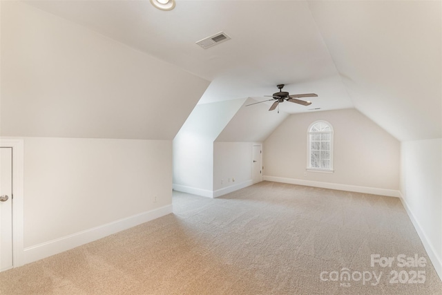 bonus room with lofted ceiling, visible vents, light carpet, and baseboards