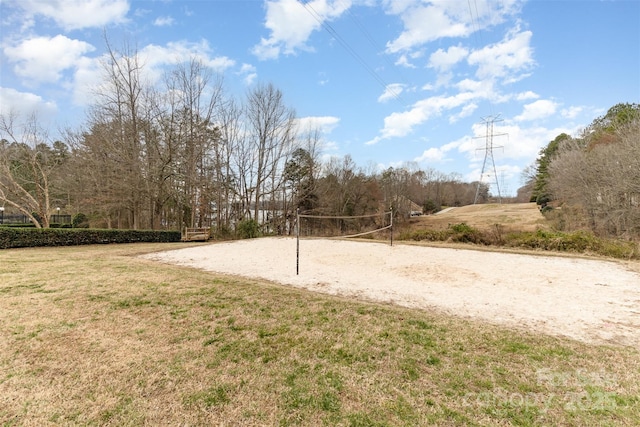 view of property's community with volleyball court and a lawn