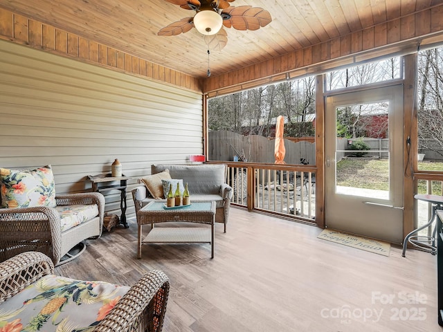 sunroom featuring wooden ceiling and ceiling fan