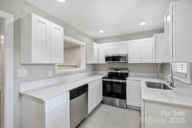 kitchen featuring white cabinetry, stainless steel appliances, and a sink