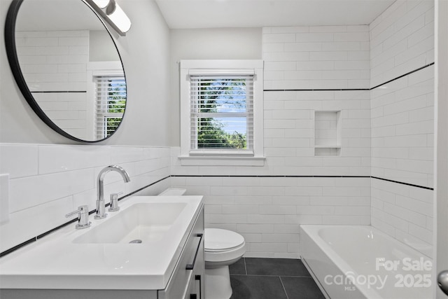 full bathroom featuring tile walls, shower / bath combination, toilet, vanity, and tile patterned flooring