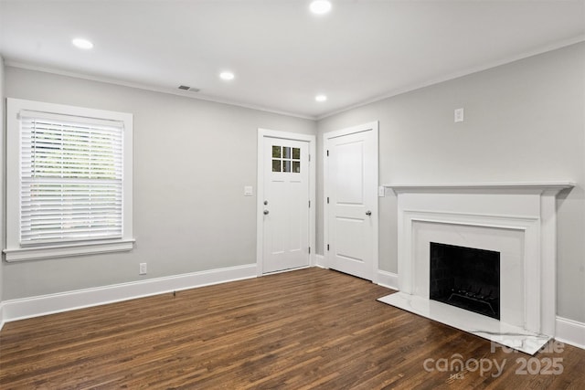 unfurnished living room with baseboards, visible vents, a premium fireplace, wood finished floors, and recessed lighting