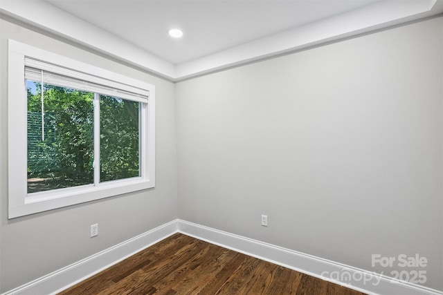 unfurnished room featuring recessed lighting, dark wood finished floors, and baseboards