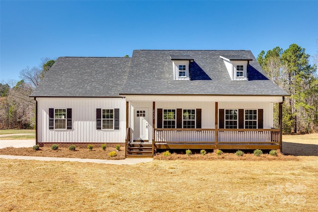 modern farmhouse with a porch and a shingled roof