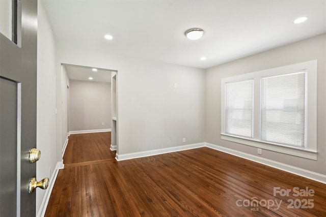 spare room with dark wood-style floors, recessed lighting, and baseboards