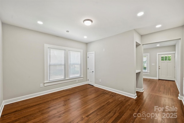 interior space featuring baseboards, dark wood-type flooring, and recessed lighting