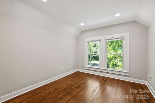 unfurnished room featuring baseboards, vaulted ceiling, dark wood-style flooring, and recessed lighting