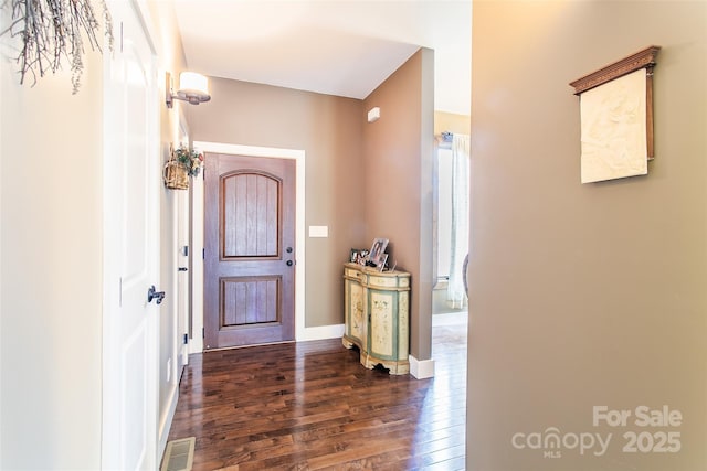 foyer with visible vents, dark wood finished floors, and baseboards