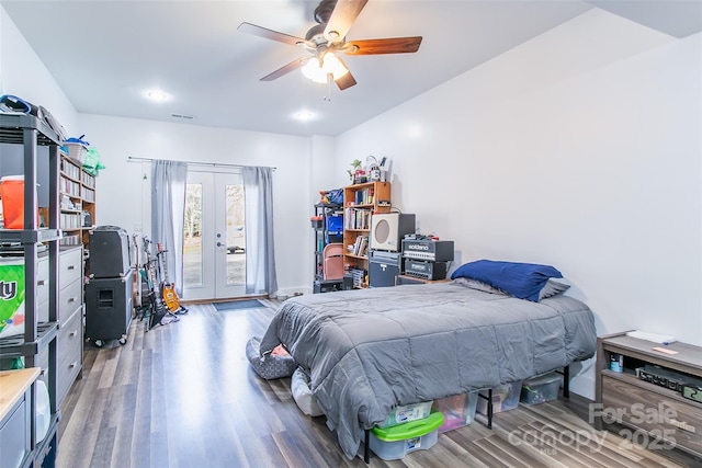 bedroom with access to exterior, french doors, visible vents, ceiling fan, and wood finished floors