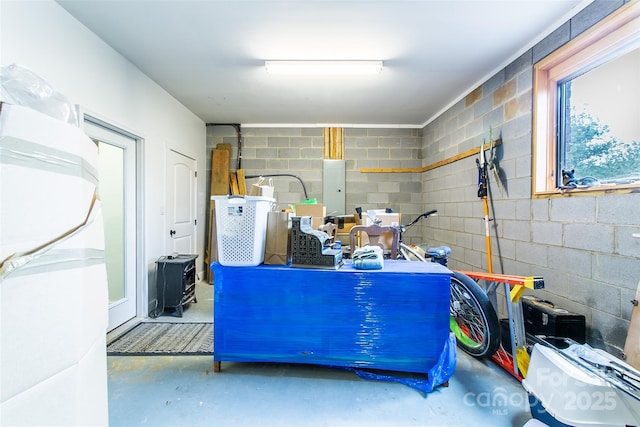 garage featuring concrete block wall and electric panel