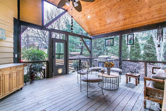 sunroom / solarium featuring wooden ceiling, ceiling fan, and vaulted ceiling