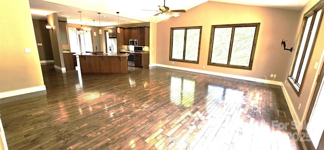 5 N Valley Dr, Weaverville, NC 28787 - kitchen featuring open floor plan, appliances with stainless steel finishes, baseboards, dark wood finished floors, and a kitchen bar