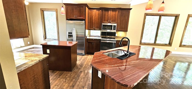 5 N Valley Dr, Weaverville, NC 28787 - kitchen with stainless steel appliances, an island with sink, a sink, hardwood / wood-style floors, and baseboards