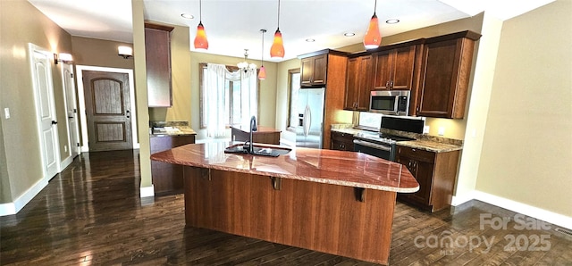 5 N Valley Dr, Weaverville, NC 28787 - kitchen featuring appliances with stainless steel finishes, a sink, baseboards, an island with sink, and light stone countertops