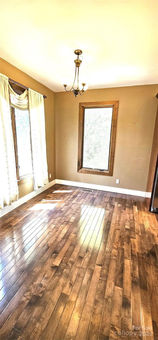 5 N Valley Dr, Weaverville, NC 28787 - spare room featuring healthy amount of natural light, wood-type flooring, a chandelier, and baseboards