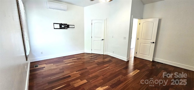 5 N Valley Dr, Weaverville, NC 28787 - unfurnished bedroom with a wall unit AC, dark wood finished floors, and baseboards