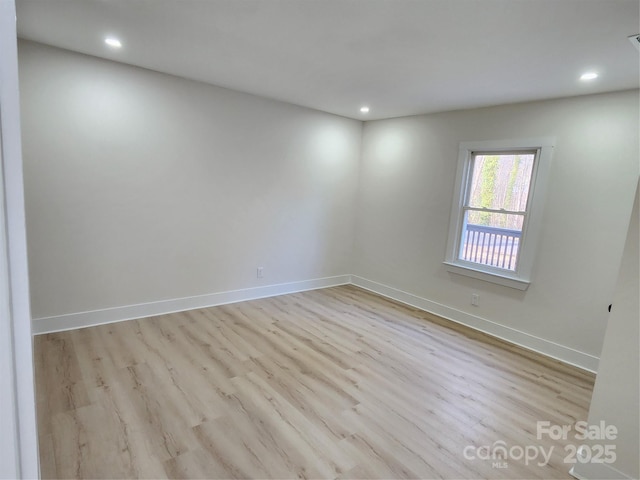 unfurnished room with recessed lighting, baseboards, and wood finished floors