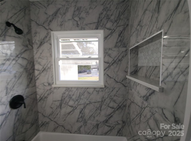 interior space with a marble finish shower