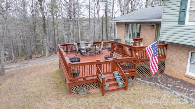 wooden terrace with outdoor dining space