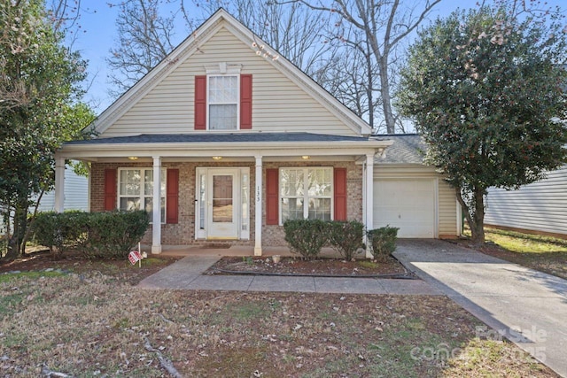 view of front of home featuring driveway, covered porch, a garage, and brick siding