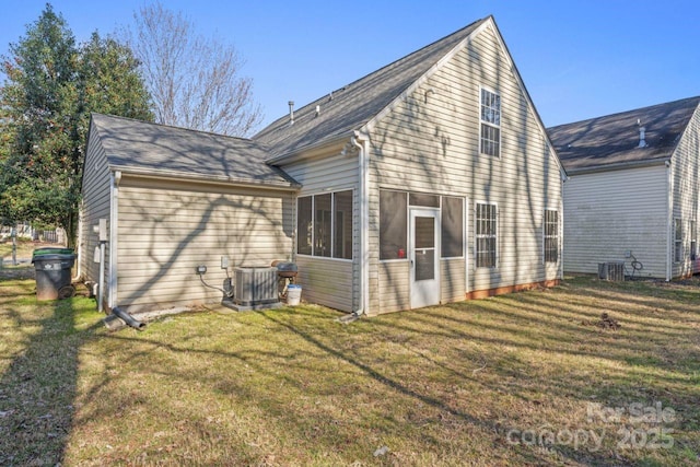 back of property with cooling unit and a lawn