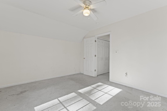 bonus room with vaulted ceiling, carpet flooring, a ceiling fan, and baseboards