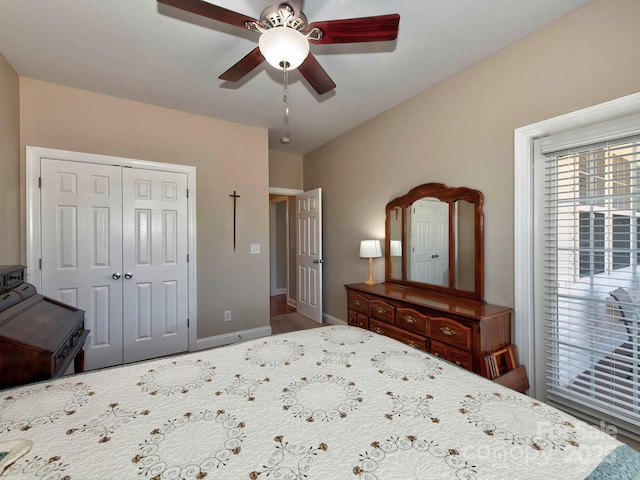 bedroom featuring ceiling fan, a closet, and baseboards