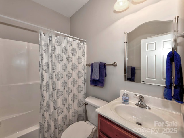 full bathroom featuring toilet, shower / bath combination with curtain, and vanity