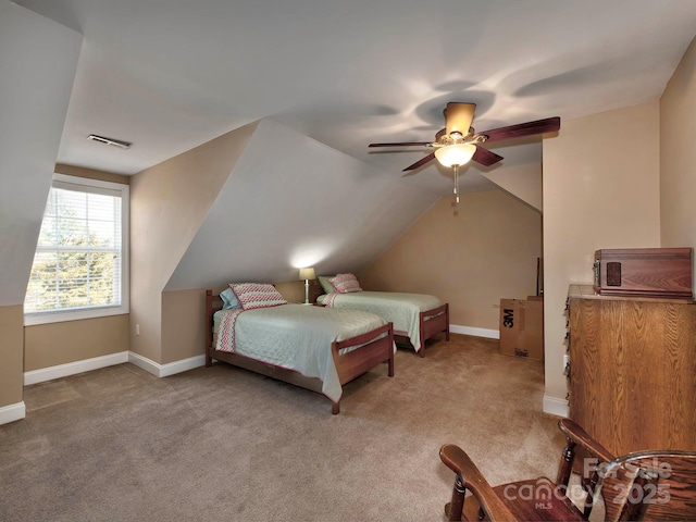 carpeted bedroom featuring vaulted ceiling, a ceiling fan, visible vents, and baseboards