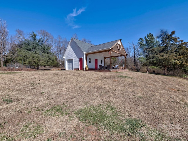 view of front of home featuring a garage, a front yard, and a porch