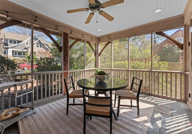 sunroom / solarium with plenty of natural light and a ceiling fan