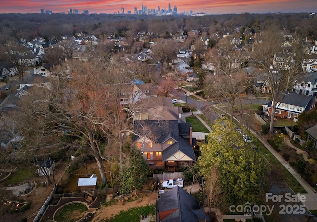 aerial view at dusk featuring a residential view