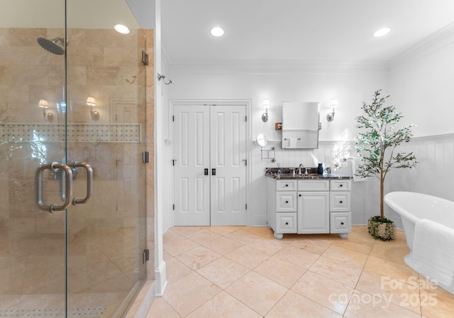 bathroom with a shower stall, ornamental molding, a freestanding bath, and vanity