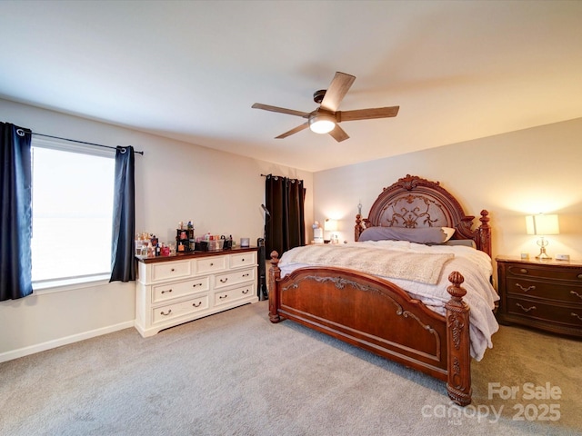 carpeted bedroom featuring ceiling fan and baseboards