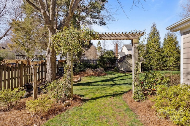 view of yard featuring a fenced backyard, a shed, and an outdoor structure