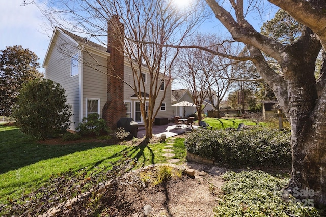 view of yard featuring a patio and fence