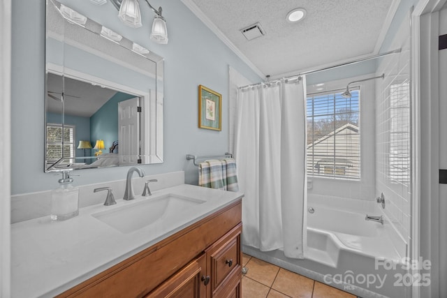 bathroom with tile patterned flooring, visible vents, a healthy amount of sunlight, and a textured ceiling