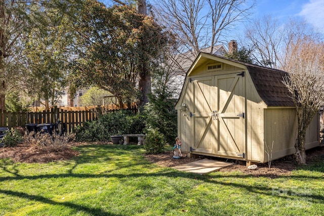 view of shed featuring fence