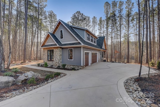 view of front of home featuring concrete driveway, a shingled roof, and an attached garage