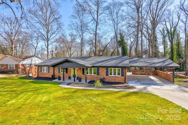 ranch-style house featuring a carport, a front yard, brick siding, and driveway